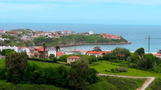Suances coastal town panoramic view, Cantabria, Spain. Elevated green landscape over ocean coastline and Cantabrian Sea. High quality 4k footage