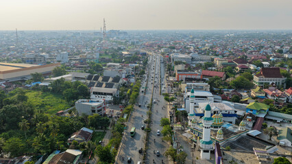 Fototapeta premium Bustling city streets and a mosque architecture seen from above in Banjarmasin, South Kalimantan