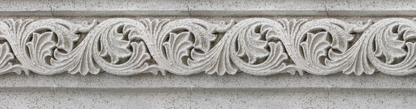 Ornate stone carving displaying classical floral architectural frieze