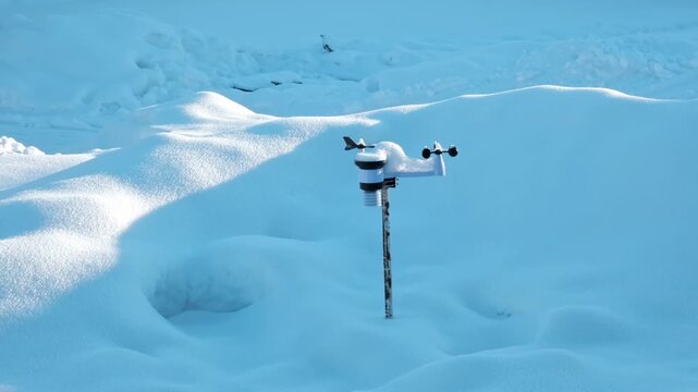 Wireless weather station on pole in snow. Sensors of temperature and humidity, Rain gauge and snow, Wind speed and direction. Climate monitoring, atmospheric research, Meteorological equipment. 4K.