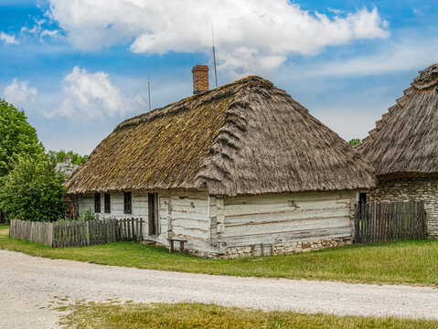 Thatched Cottage in Rural Village With Whitewashed Log Walls and Traditional Thatch Roof