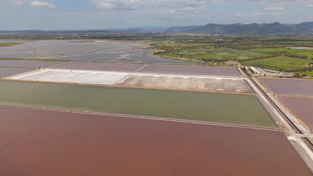 Coastal Salt Evaporation Ponds On Sant'Antioco Island In South Sardinia, Italy. Aerial Wide Shot