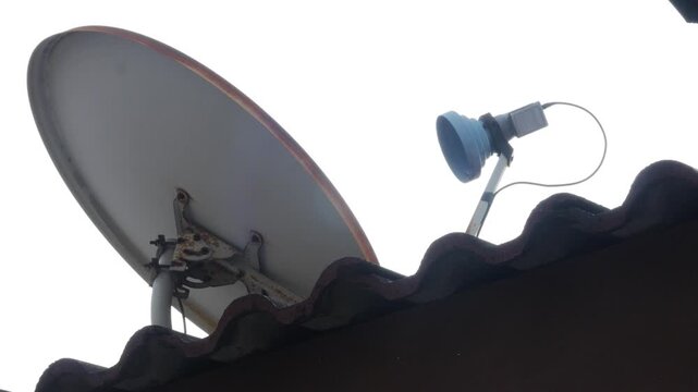 Satellite Dish Mounted on House Roof