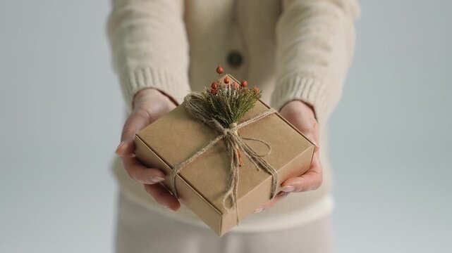 Person Holding a Wrapped Gift Box
