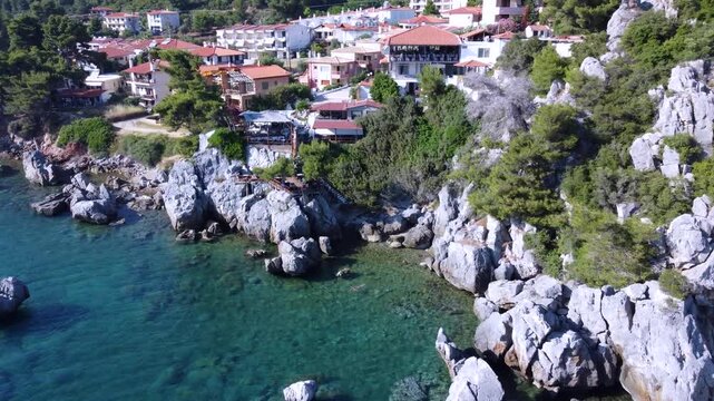 Aerial Orbit Around a Seaside Restaurant Built on a Rocky Mediterranean Coastline in Greece