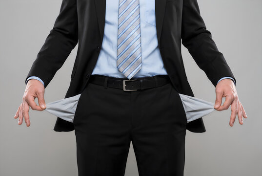 Business professional demonstrating financial struggle with empty pockets visible