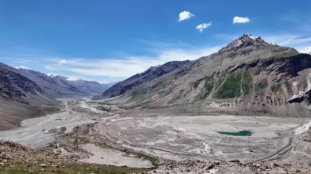 Zanskar, India : Panoramic footage of landscape of valley in Penzi la, famous mountain pass in Ladakh between Padum and Kargil, India showing curving road with Drang Drung glacier on sunny day