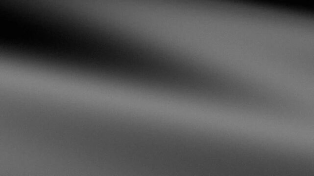Gray grainy abstract background with soft diagonal gradient and texture