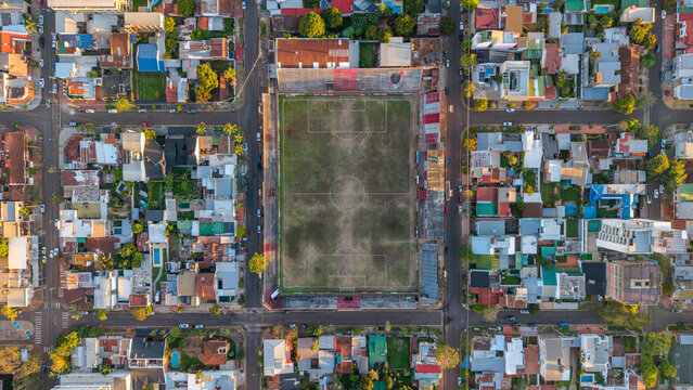 Aerial view of Club Deportivo Guarani Antonio Franco stadium surrounded by dense urban residential blocks and streets in Posadas, Misiones, Argentina.