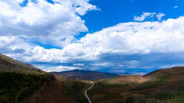 Aerial view of a winding road cutting through the mountainous landscape of Granby, Colorado, United States.