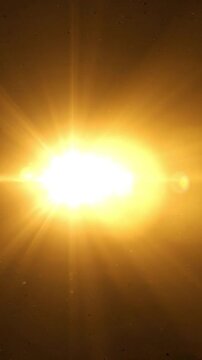 Bright golden sun flare with light leaks on dark background