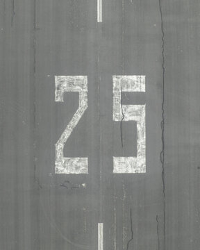 Aerial view of the Landebahn Neubiberg runway showing the number 25 painted on the asphalt surface Unterhaching, Bavaria, Germany.