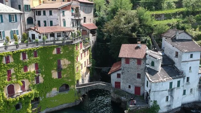 Drone view of Nesso, Lake Como, Italy, with Orrido waterfall, stone bridge and ivy covered house