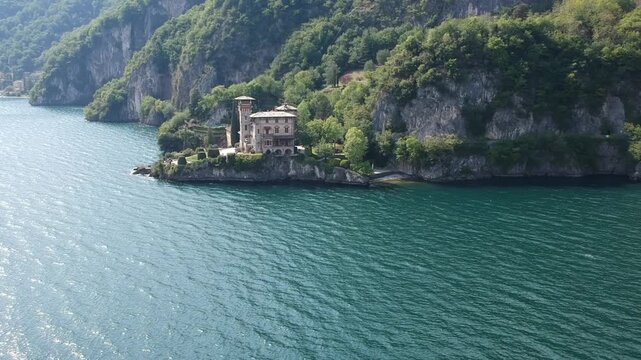 Drone panorama of Villa La Gaeta, Lake Como, Italy, surrounded by blue water and alpine hills