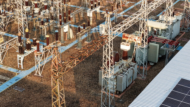 Aerial view of an electrical power substation with distribution equipment and metal transformers