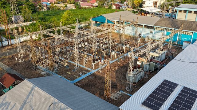Aerial view of a power substation with electrical transformers and steel towers in Banjarmasin