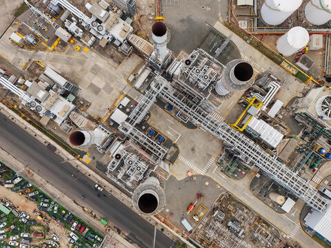 Aerial view of the Parque Electrico Los Mina power plant featuring industrial chimneys, storage tanks, and complex piping systems in Santo Domingo, Santo Domingo, Dominican Republic.