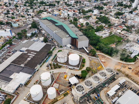 Aerial view of Parque Electrico Los Mina featuring large industrial storage tanks, cooling towers, and surrounding urban infrastructure in Santo Domingo, Santo Domingo, Dominican Republic.