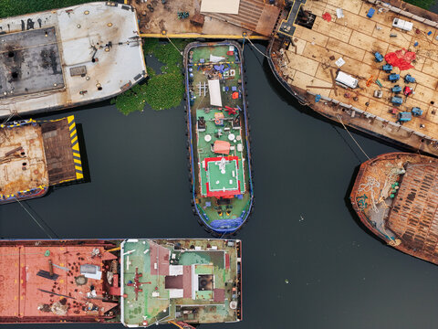 Aerial view of various barges and a tugboat navigating the Rio Ozama in Santo Domingo, Distrito Nacional, Dominican Republic.
