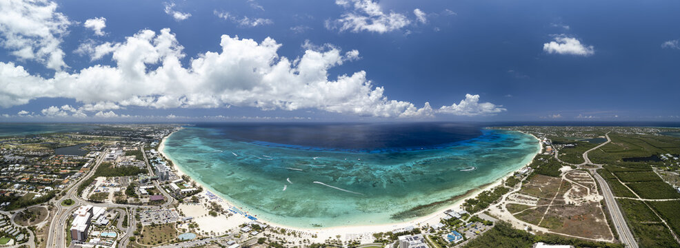 Aerial view of Seven Mile Beach with turquoise waters, white sand, and coastal development in Grand Cayman, Cayman Islands.