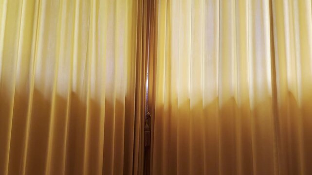 Warm sunlight filters through soft orange curtains, creating a cozy moody morning interior ideal for slow living, wellness, hospitality, and lifestyle content.