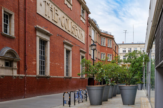 London - 07 22 2022: Mays Court brick building with planters and modern glass frontage