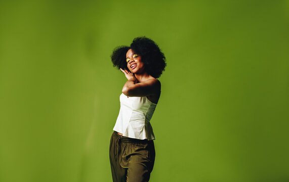 Woman wears a joyful smile in a relaxed lifestyle studio portrait