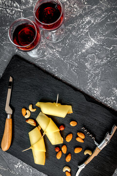 red wine with cheese on dark background top view