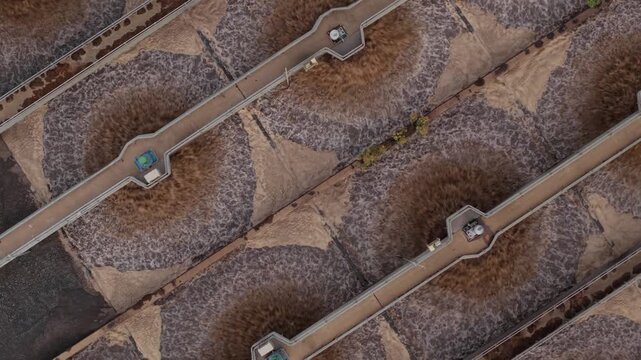 Aerial view of circular aeration tanks and walkways at the Severn Trent Wanlip water treatment plant in Wanlip, England, United Kingdom.