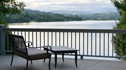 Fototapeta premium Empty deck furniture sits on a balcony overlooking a scenic lake on a quiet summer afternoon