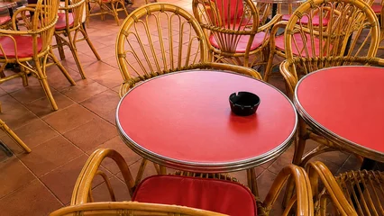 Fototapete Gastronomie Outdoor Cafe with Red Tables and Wicker Chairs  © Dinadesign