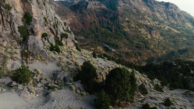 Los Arenales area in Nevado de Colima (Zapotepetl) National Park showing steep rocky slopes, volcanic terrain and scattered pine trees in Jalisco, Mexico. Aerial view.