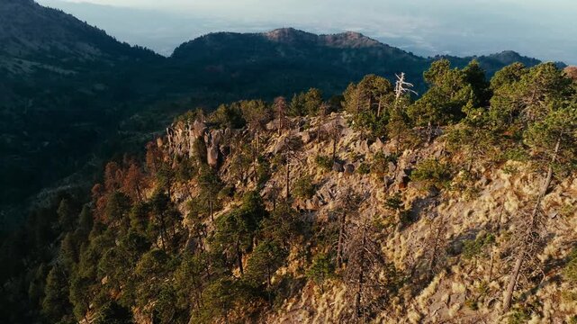 Nevado de Colima (Zapotepetl) rocky forested ridge in Jalisco, Mexico. Dolly in aerial view.