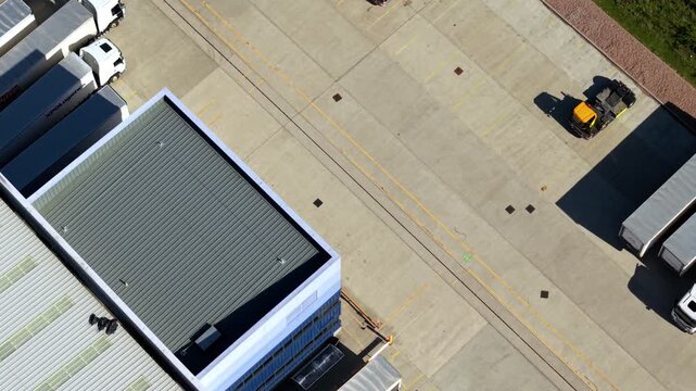 Close-Up Aerial View of Articulated Lorries in Loading Bays at Logistics Hub