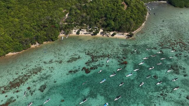 # Microstock Description Aerial view of Alano Beach on Karimunjawa Island, Indonesia, featuring pristine white sand, turquoise ocean water, and a tranquil tropical coastline.