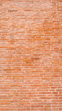 An old wall made of mud bricks in various shades of brown