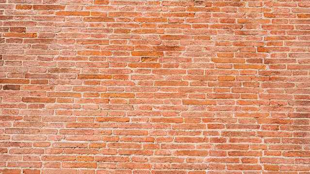 An old wall made of mud bricks in various shades of brown