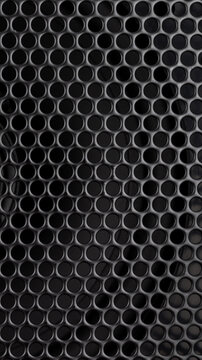 Black metal speaker grille with circular perforated mesh pattern, industrial sound equipment texture