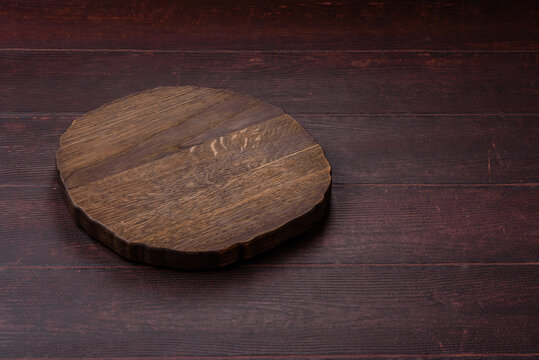 A square wooden cutting board for home food preparation. A wooden cutting board