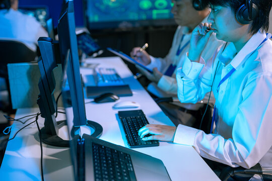 air traffic controller monitors flight radar screens in a modern dark command center, aviation technology, flight safety, surveillance and precision.