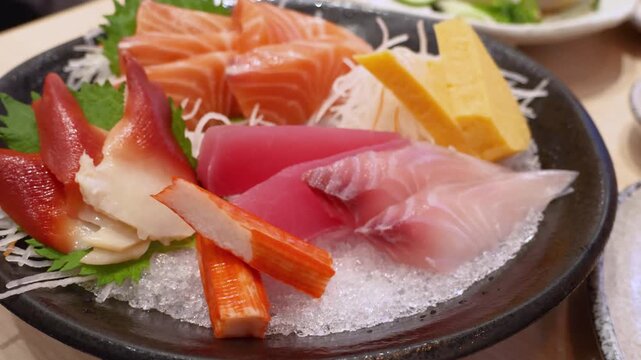 Mixed premium sashimi bowl including salmon, tuna, hamachi and tamago on ice