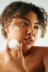Confident young african american woman showcasing her beauty and elegance with skin care