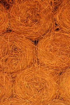 Vertical abstract background texture of natural coconut coir fiber rolls for erosion control and agriculture.