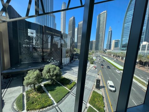 Dubai, United Arab Emirates - March 14, 2023: Exterior view of the famous Dubai Mall complex in Downtown Dubai, featuring modern architectural design, waterfront promenades, and city skyline views on 