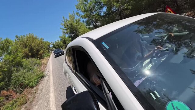 Male Tourist Recording Travel Vlog From Car Window