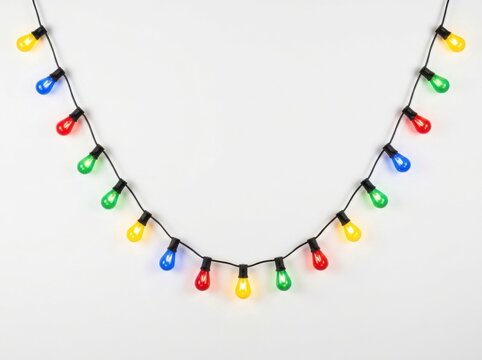 Colorful decorative christmas string lights hanging in a curve isolated on white background