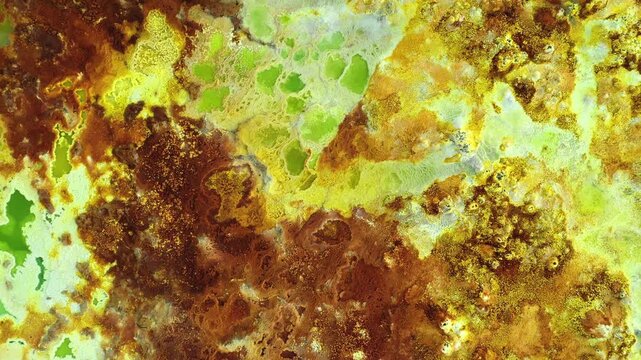 Aerial view of the colorful geothermal area in Dalol, showcasing vibrant mineral deposits, sulfur springs, and salt formations in Dalol, Afar, Ethiopia.