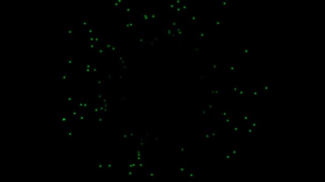 Abstract background with glowing green particles floating in dark space.