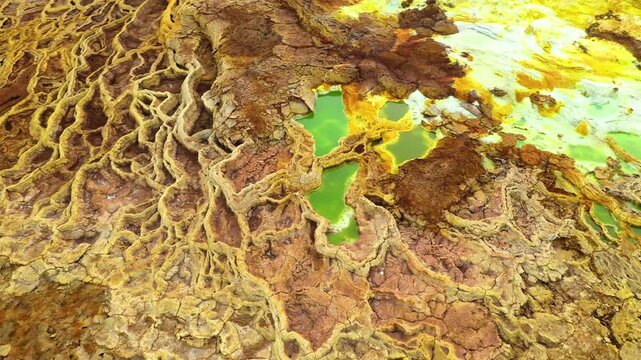 Aerial view of the vibrant, multi-colored salt formations and acidic hot springs of the Dallol geothermal area in Dalol, Afar, Ethiopia.
