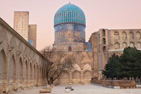 Bibi Khanym Mosque turquoise dome and courtyard at sunset in Samarkand, Uzbekistan. Ideal for travel publications, cultural heritage materials, and architecture features.